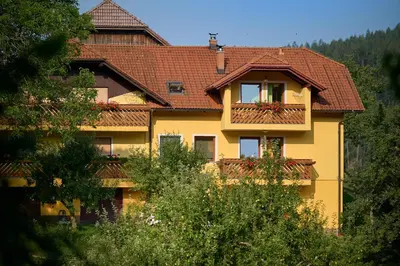 a yellow house with a balcony on the side of it at Farm Stay Gradišnik Peaceful Countryside with Homemade Breakfast in Prevalje
