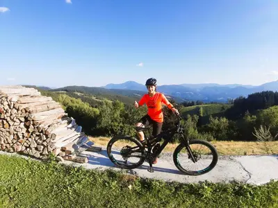 a young boy riding a bike on a road at Farm Stay Gradišnik Peaceful Countryside with Homemade Breakfast in Prevalje