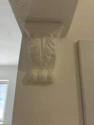 a white vase on the corner of a wall at Vila Marla in Hrušica