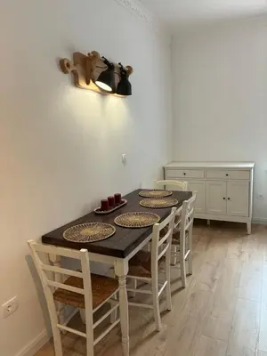 a dining room with a table and some chairs at Vila Marla in Hrušica