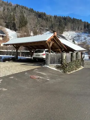 a car parked in a parking lot with a roof at Vila Marla in Hrušica