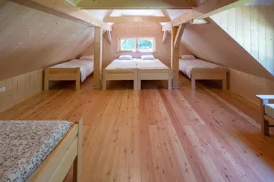 a room with two beds in a attic at Alpine Loghouse Planšarska bajta Matkov Kot in Solčava
