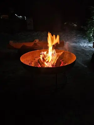 a fire pit in a yard at night at Cosy Rogla appartment 108 in Zreče