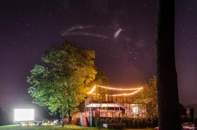 a building with lights on it at night at VRBA Premium riverside mobile house BIG BERRY in Gradac