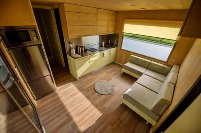 an overhead view of a living room and kitchen in a tiny house at VRBA Premium riverside mobile house BIG BERRY in Gradac