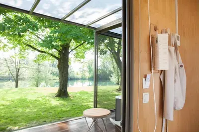 a sliding glass door with a view of a tree at VRBA Premium riverside mobile house BIG BERRY in Gradac