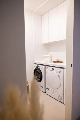 a white laundry room with a washing machine at Lanina Chalet Luxury Mountain Escape in Pohorje