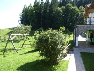 a garden with a swing and a playground at Apartma Spodnji Goltnik 1 in Mozirje