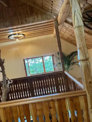 a wooden staircase in a house with a window at Apartma Spodnji Goltnik 1 in Mozirje