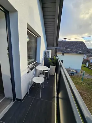 a balcony with tables and chairs on a building at Apartment Čebelica in Lesce