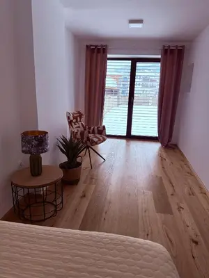 a living room with a bed and a large window at Villa Vita - GLORIA in Slovenj Gradec