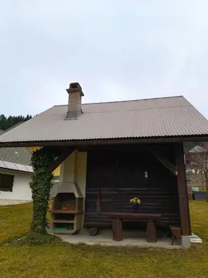 a house with a bench in front of it at Apartma Pirc in Kranjska Gora