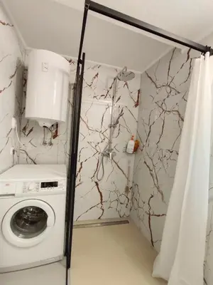 a laundry room with a washer and dryer at Apartma Pirc in Kranjska Gora