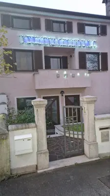 a pink building with a gate in front of it at Mark & Lana in Sežana