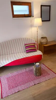 a room with a bed with a red rug at Cozy wabi-sabi retreat w bikes by the river in Bohinj