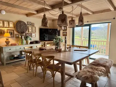 a kitchen with a large wooden table and chairs at Private Villa for 12 Peaceful Karst Escape in Dutovlje