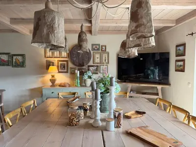 a dining room with a wooden table with chairs at Private Villa for 12 Peaceful Karst Escape in Dutovlje