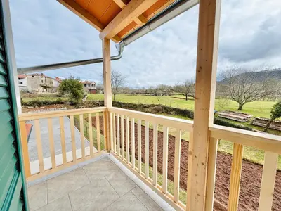 a view from the balcony of a cabin with a view at Private Villa for 12 Peaceful Karst Escape in Dutovlje