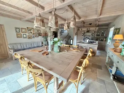 a dining room with a large wooden table and chairs at Private Villa for 12 Peaceful Karst Escape in Dutovlje