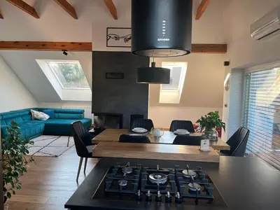 a kitchen and living room with a stove and a couch at Eden Superior Family Apartment near Terme Paradiso with FREE pool tickets in Dobova