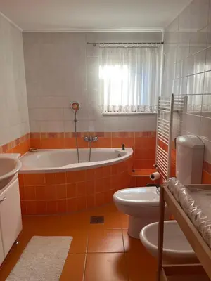 a bathroom with a tub and a toilet and a sink at Eden Superior Family Apartment near Terme Paradiso with FREE pool tickets in Dobova