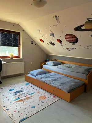 two beds in a room with planets painted on the wall at Eden Superior Family Apartment near Terme Paradiso with FREE pool tickets in Dobova