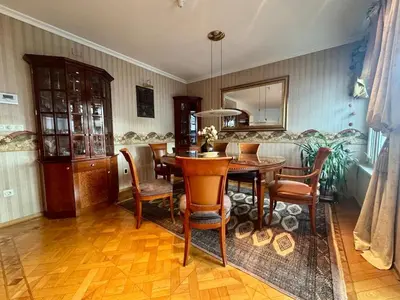 a dining room with a table and chairs at Peaceful & Spacious Villa With A Beautiful Garden in Ljubljana