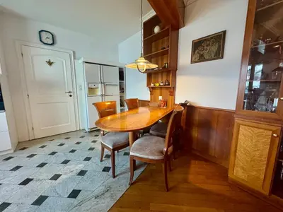 a dining room with a wooden table and chairs at Peaceful & Spacious Villa With A Beautiful Garden in Ljubljana