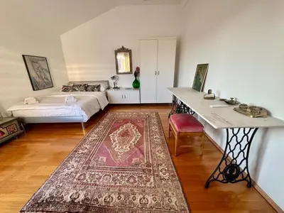 a large room with two beds and a rug at Peaceful & Spacious Villa With A Beautiful Garden in Ljubljana
