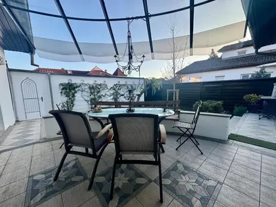 a patio with a table and chairs on a patio at Peaceful & Spacious Villa With A Beautiful Garden in Ljubljana