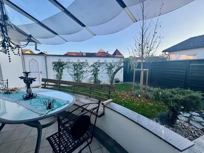 a patio with a table and chairs and a fence at Peaceful & Spacious Villa With A Beautiful Garden in Ljubljana