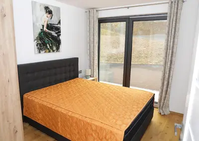a bedroom with a bed and a window at Apartma Belvi in Brežice