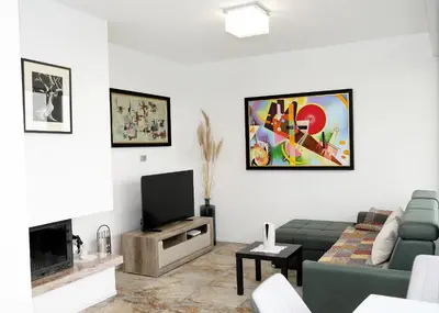 a living room with a couch and a tv at Apartma Belvi in Brežice