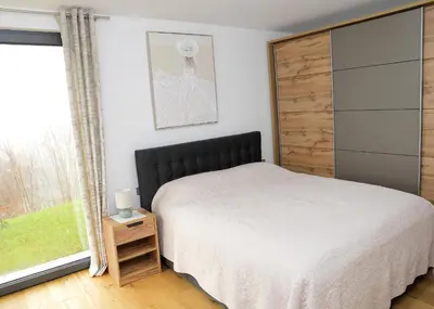 a bedroom with a bed and a window at Apartma Belvi in Brežice