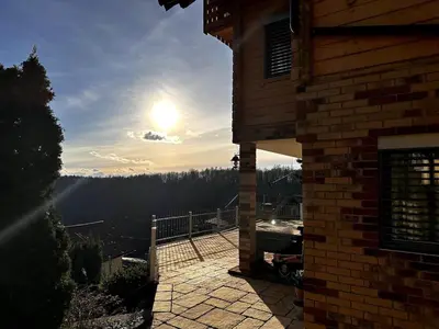 a view of the sun setting from a house at Luxury Panorama Villa • Pool, Quadro Sauna & Views