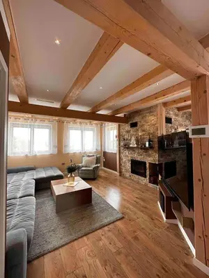 a living room with a couch and a fireplace at Luxury Panorama Villa • Pool, Quadro Sauna & Views