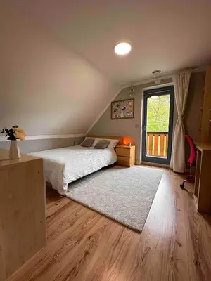 a bedroom with a bed and a large window at Luxury Panorama Villa • Pool, Quadro Sauna & Views