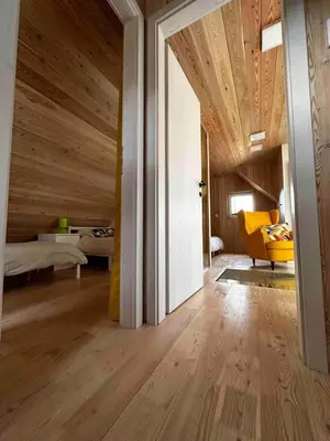 a room with a wooden ceiling and a room with a bed at Secluded Romantic Cabin · Hot Tub & Barrel Sauna