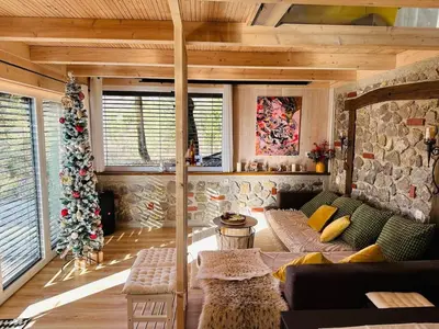 a living room with a christmas tree and a couch at Secluded Romantic Cabin · Hot Tub & Barrel Sauna