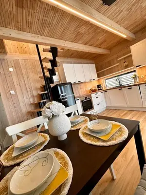 a kitchen with a table with plates on it at Secluded Romantic Cabin · Hot Tub & Barrel Sauna