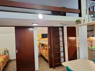 a loft bed in a room with a bedroom at Boho House 6 camp Terme Catez with promotional tickets prices in Čatež ob Savi