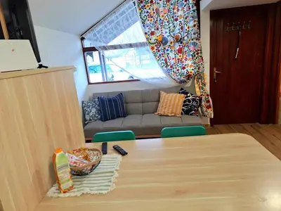 a living room with a table and a couch at Boho House 6 camp Terme Catez with promotional tickets prices in Čatež ob Savi