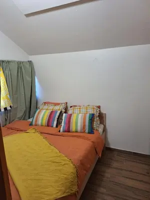 a bed with two pillows on it in a room at Boho House 6 camp Terme Catez with promotional tickets prices in Čatež ob Savi