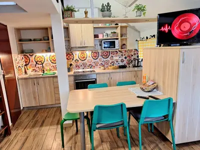 a kitchen and dining room with a table and chairs at Boho House 6 camp Terme Catez with promotional tickets prices in Čatež ob Savi