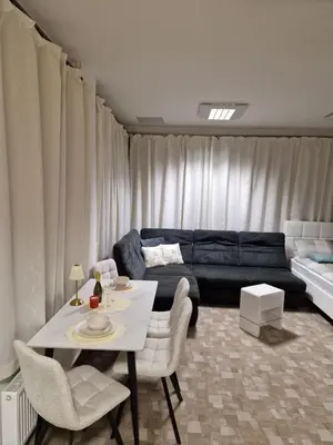a living room with a couch and a table and chairs at Apartment TINA in Kranjska Gora