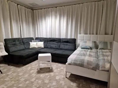 a living room with a couch and a bed at Apartment TINA in Kranjska Gora