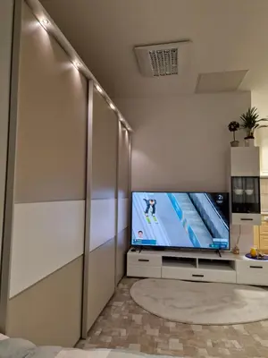 a living room with a flat screen tv on a wall at Apartment TINA in Kranjska Gora
