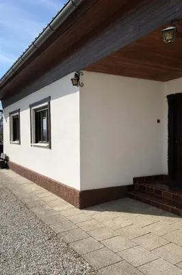 a white building with a window and a door at Apartments Vila Ančka in Tržič