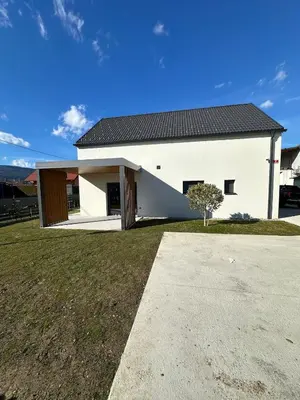a white house with a black roof at Lanina Estate in Spodnje Hoče