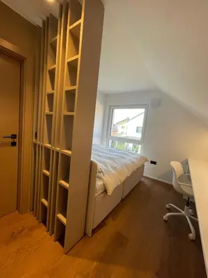a bedroom with a bed and a desk and a window at Lanina Estate in Spodnje Hoče